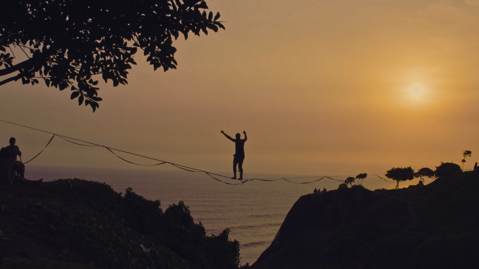 Man balancing on a tightrope during sunset.jpg